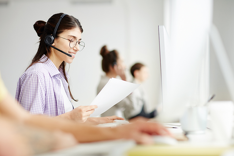 AdobeStock_193436491B Young Woman at a Call Center